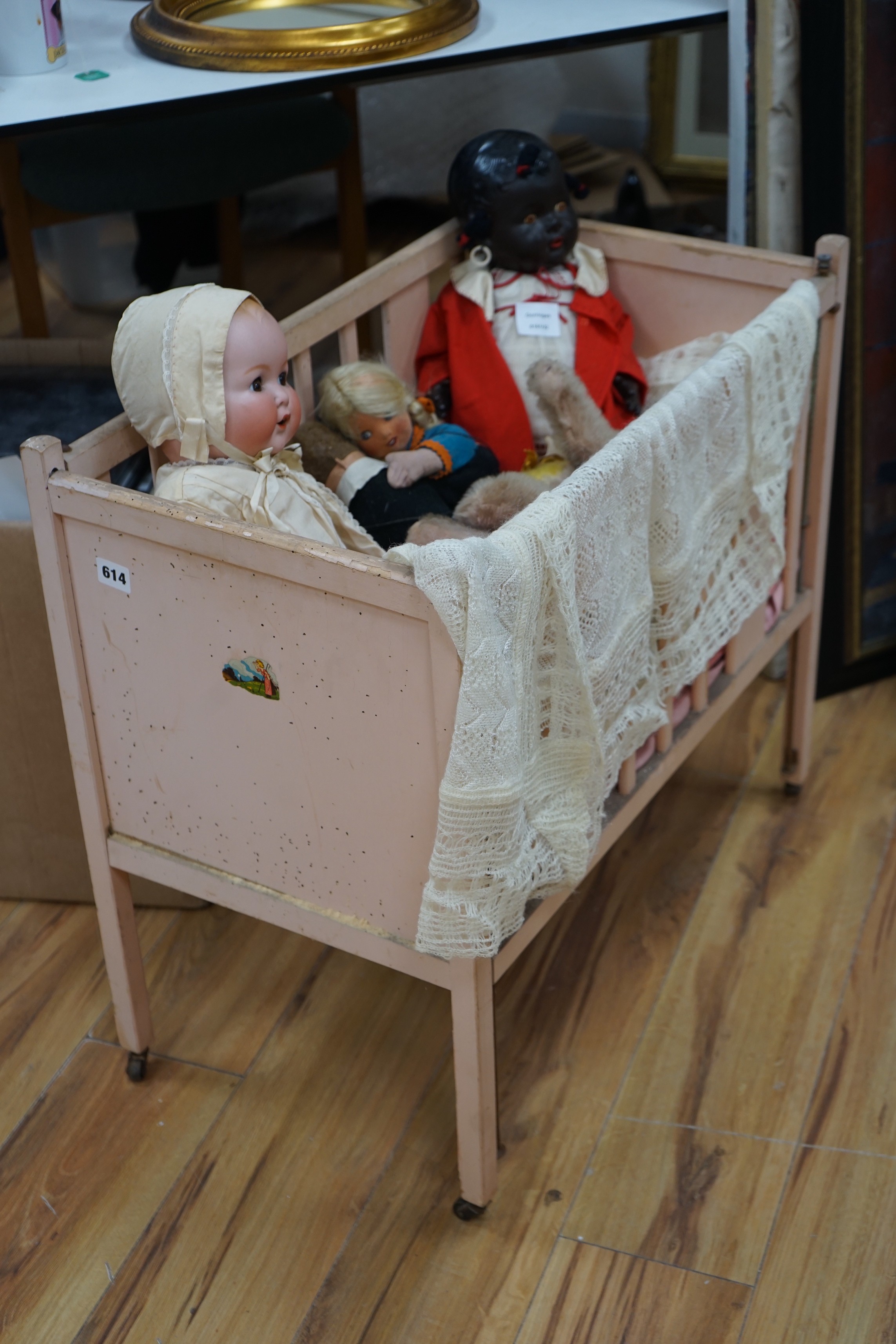An Armand Marseille bisque head baby doll, a black plastic doll and other dolls and toys